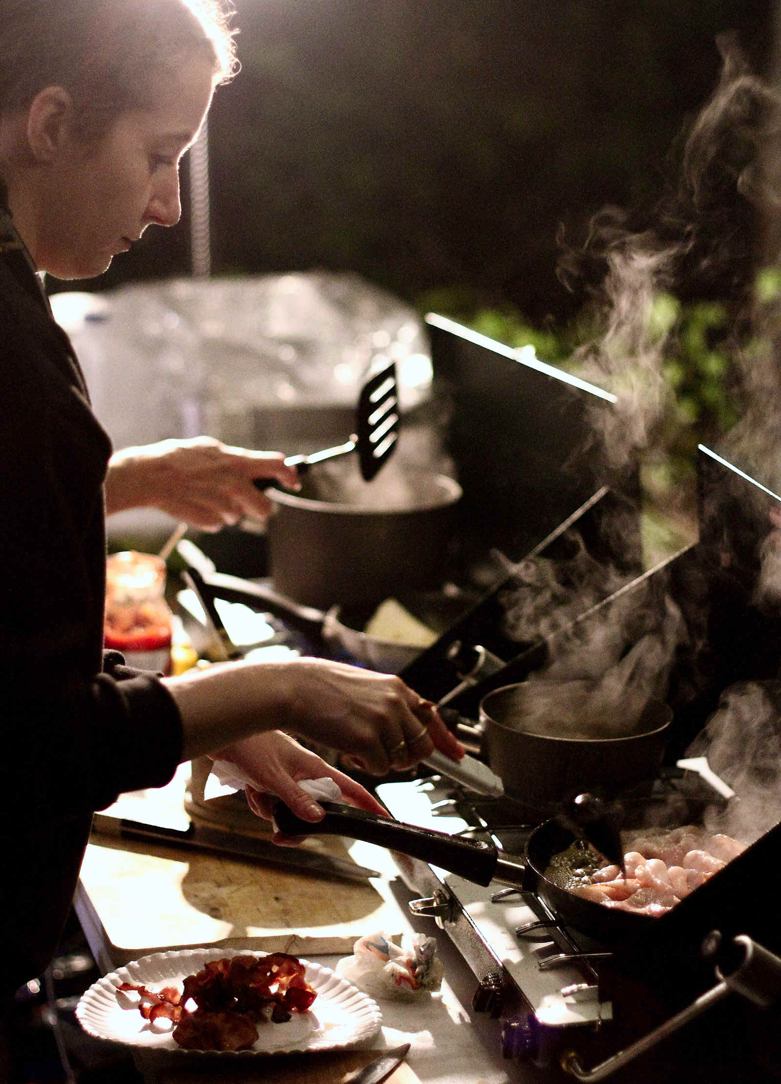 Volunteer Samantha Neakrase cooks breakfast at an aid station during the 2015 MMT 100
